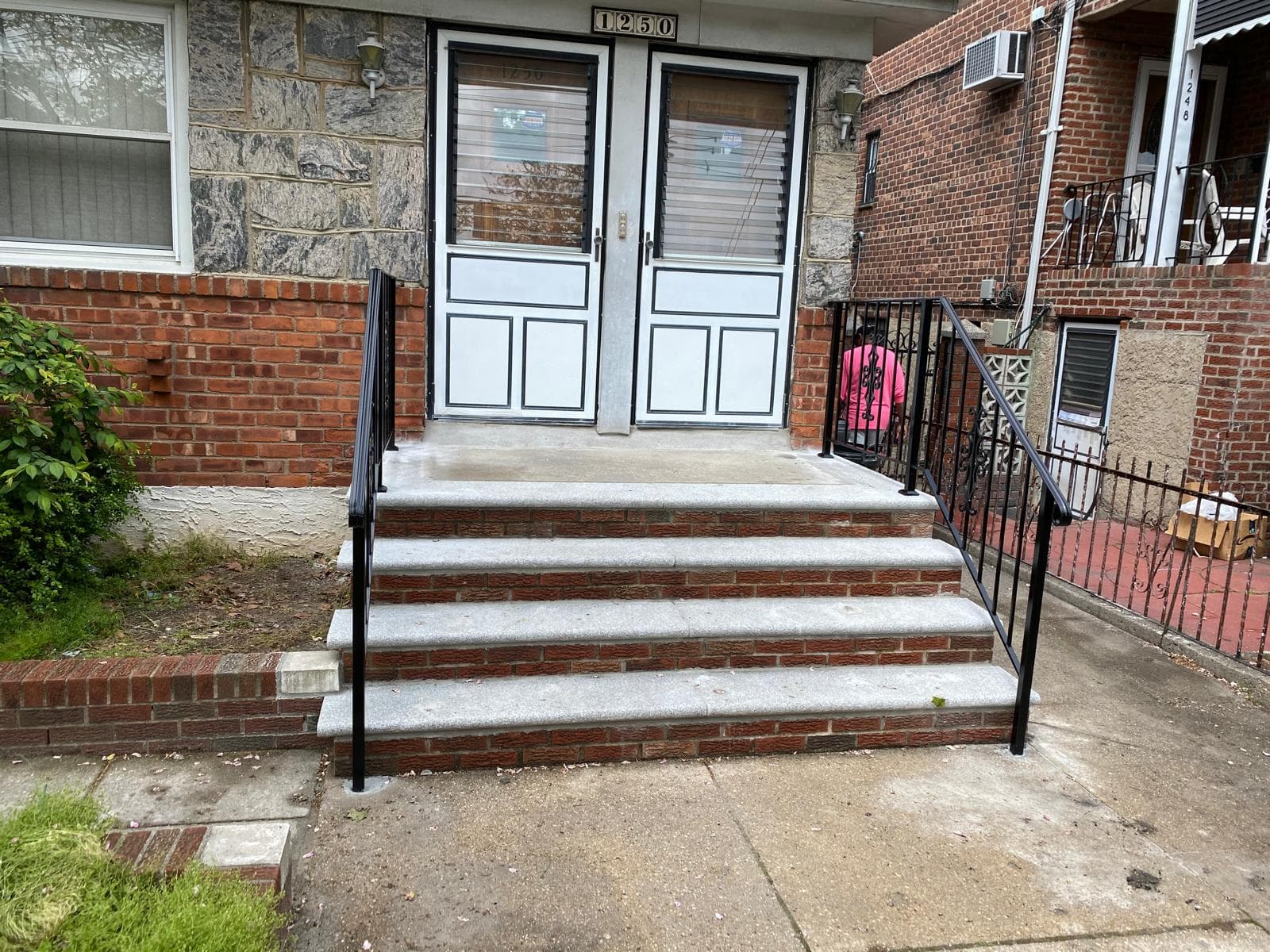 Modern staircase in Brooklyn apartment with custom wood and metal handrail