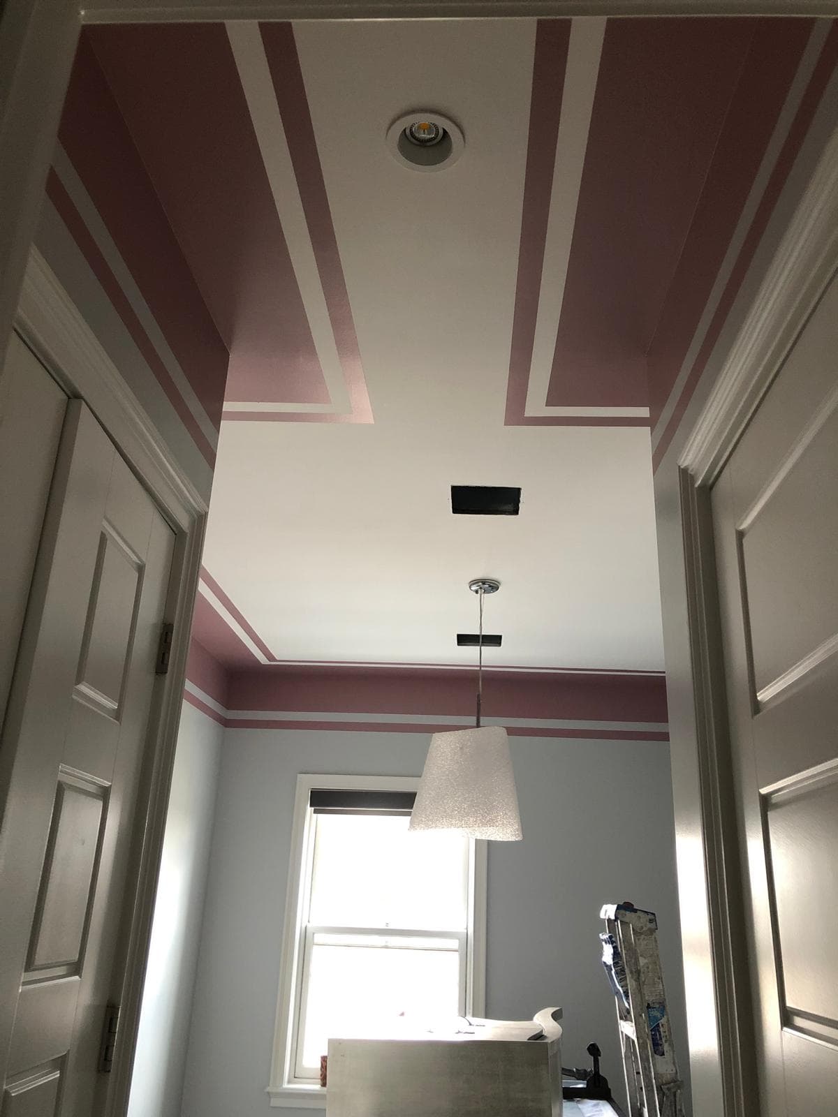 Modern interior wall painted with geometric stripe design in contrasting gray and white tones, Brooklyn, NY